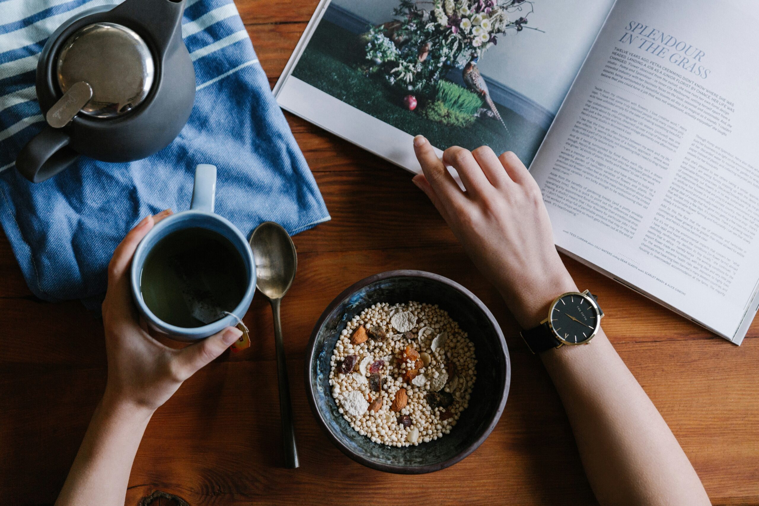 Top view of a person having coffee and breakfast with a smartwatch on the wrist